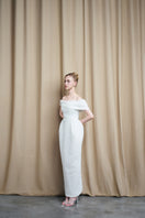 Ivory off-shoulder drape sequin gown by HACCHIC COUTURE, featuring elegant flowing fabric and intricate sequin details.