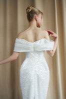 Hacchic Couture ivory off-shoulder drape gown with sequin embellishments, flowing fabric, and elegant design for formal occasions.