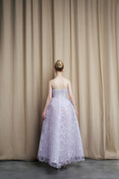 Elegant strapless lilac tulle ball gown by HACCHIC COUTURE featuring a flowing skirt and fitted bodice, perfect for formal occasions.