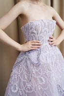 Elegant strapless lilac tulle ball gown by HACCHIC COUTURE, featuring a flowing skirt and fitted bodice, perfect for formal occasions.