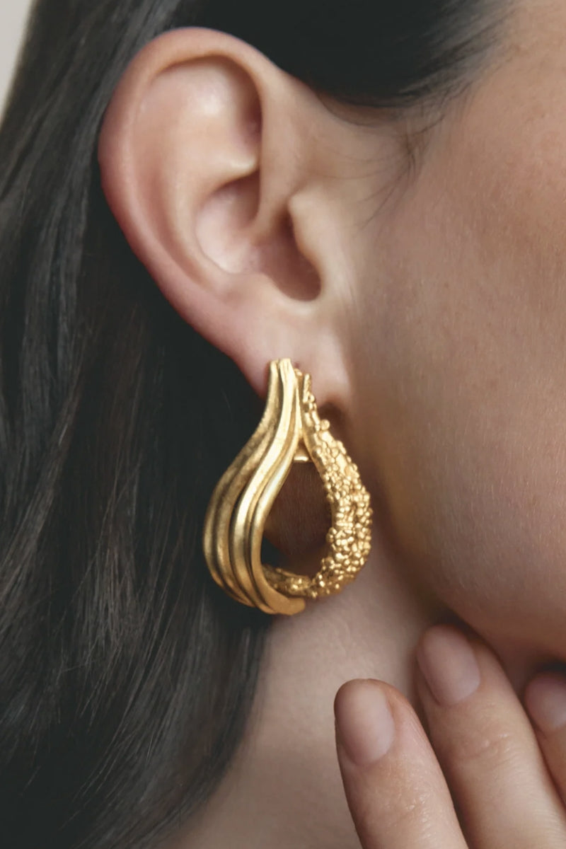 Gold and white Jude Benhalim loop hoops earrings with a sleek, circular design perfect for stylish accessorizing.