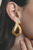 Gold and white Jude Benhalim loop hoops earrings with a sleek, circular design perfect for stylish accessorizing.