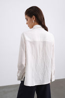 SÉLONE Lorin asymmetric stripe shirt in ecru with bold vertical and horizontal stripe patterns displayed on the front.