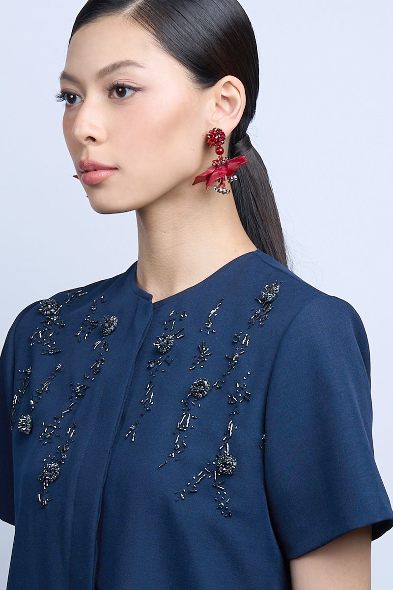 Red dew drop earrings by Aidan & Ice featuring teardrop-shaped design and vibrant red color for a stylish look.