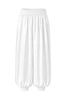 White Izakova Marea Pants laid flat, showing slim-fit design and clean fabric with subtle stitching details.