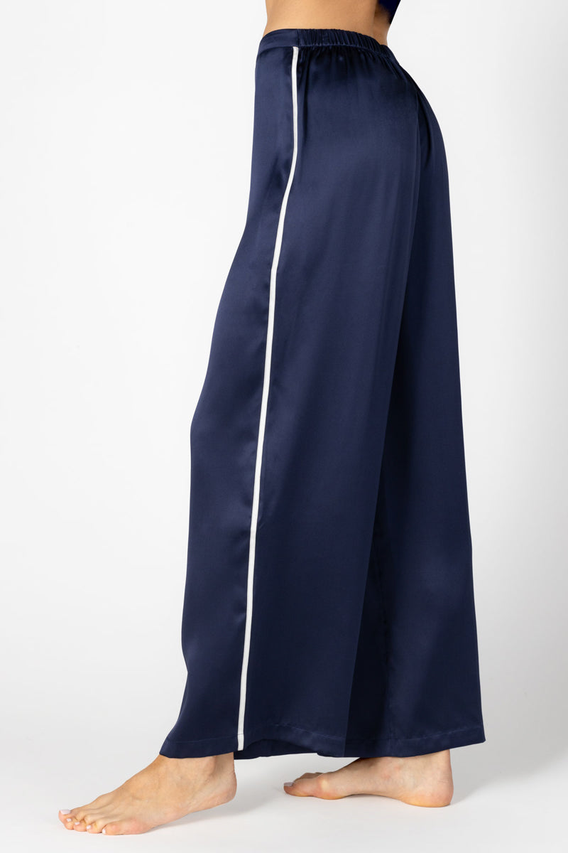 Side profile of NK IMODE Marisa Charming Lounge Silk Trouser in elegant evening blue, showcasing smooth silk fabric and relaxed fit.