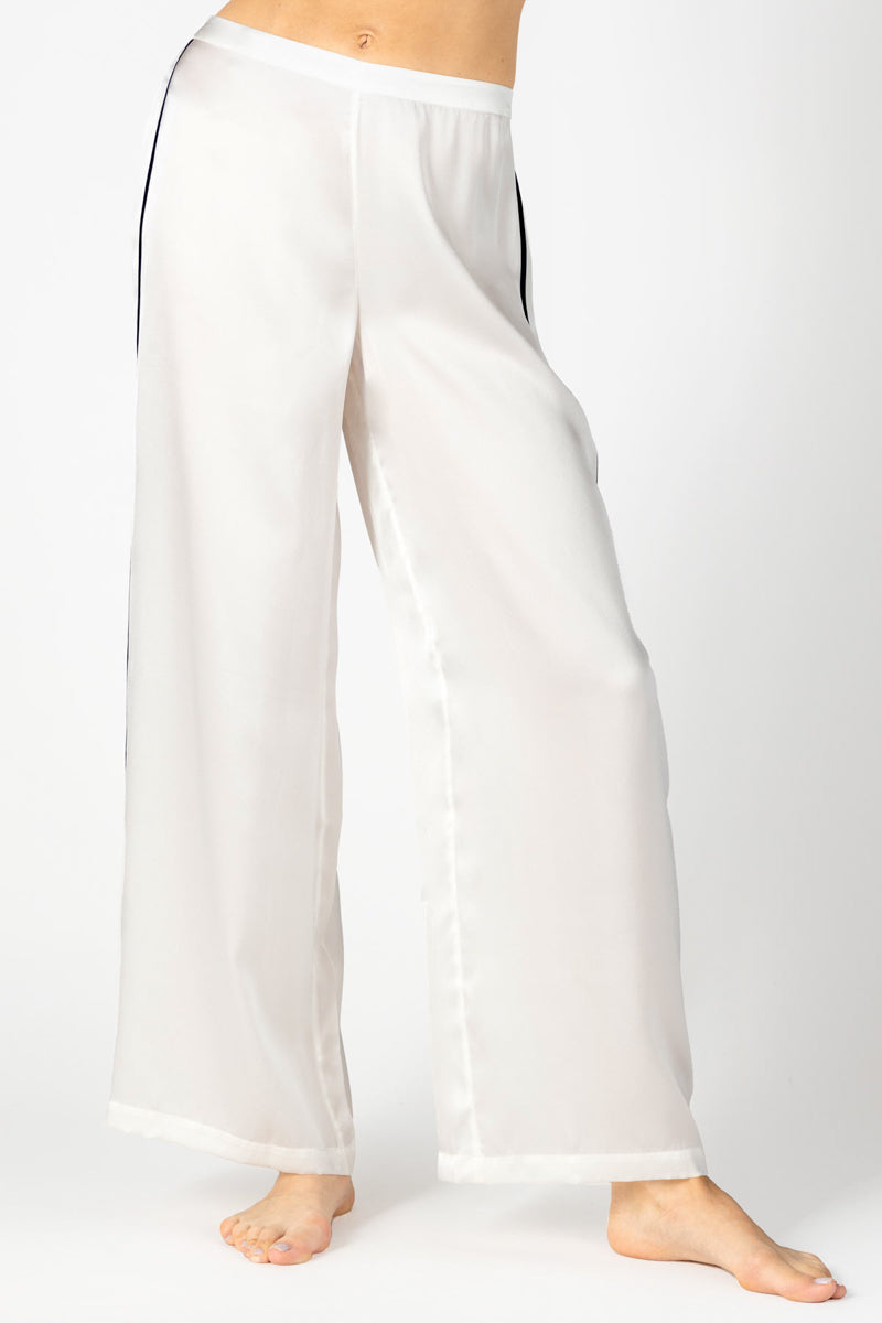 Front profile of NK IMODE Marisa charming silk lounge trousers in ivory, showcasing a relaxed fit and smooth silk fabric.