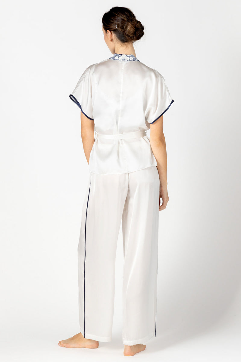 Back profile of NK IMODE Marisa charming silk kimono wrap jacket in ivory, showcasing its elegant loungewear design and flowing fabric.