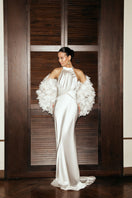 Matters Lilia white gown displayed on a model, elegant long dress with delicate fabric and flowing design.