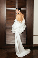 White gown by MATTERS featuring elegant fabric and a flowing silhouette, perfect for formal occasions.
