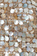 Close-up of Mirel Prentice crochet Mother of Pearl top, showcasing intricate crochet details and iridescent pearl accents.