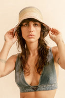 Modern Monarchie Poppy Rainbow Straw Bucket Hat with colorful rainbow pattern and wide brim for sun protection.