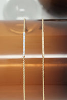 EDXÚ Morse Bridge Bracelet in matte gold with baguette and princess-cut diamonds, showcasing elegant jewelry design.