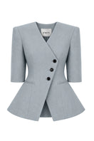 Izakova NELA blazer in washed blue, tailored fit with lapel collar and single-button closure, displayed on a hanger.