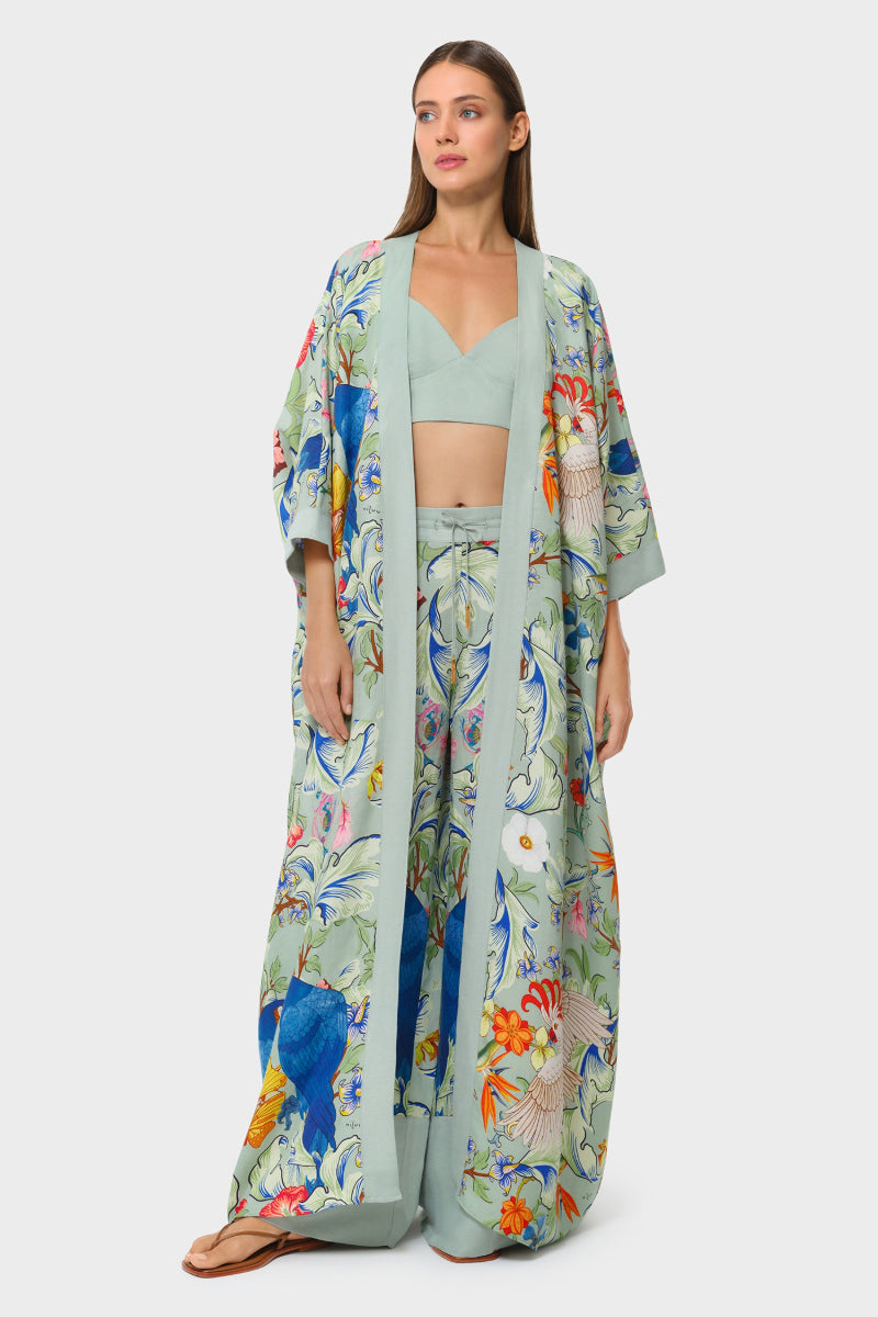 Nilu CARMEN Kaftan cover-up with vibrant colorful patterns and flowing fabric, perfect for beach or poolside wear.