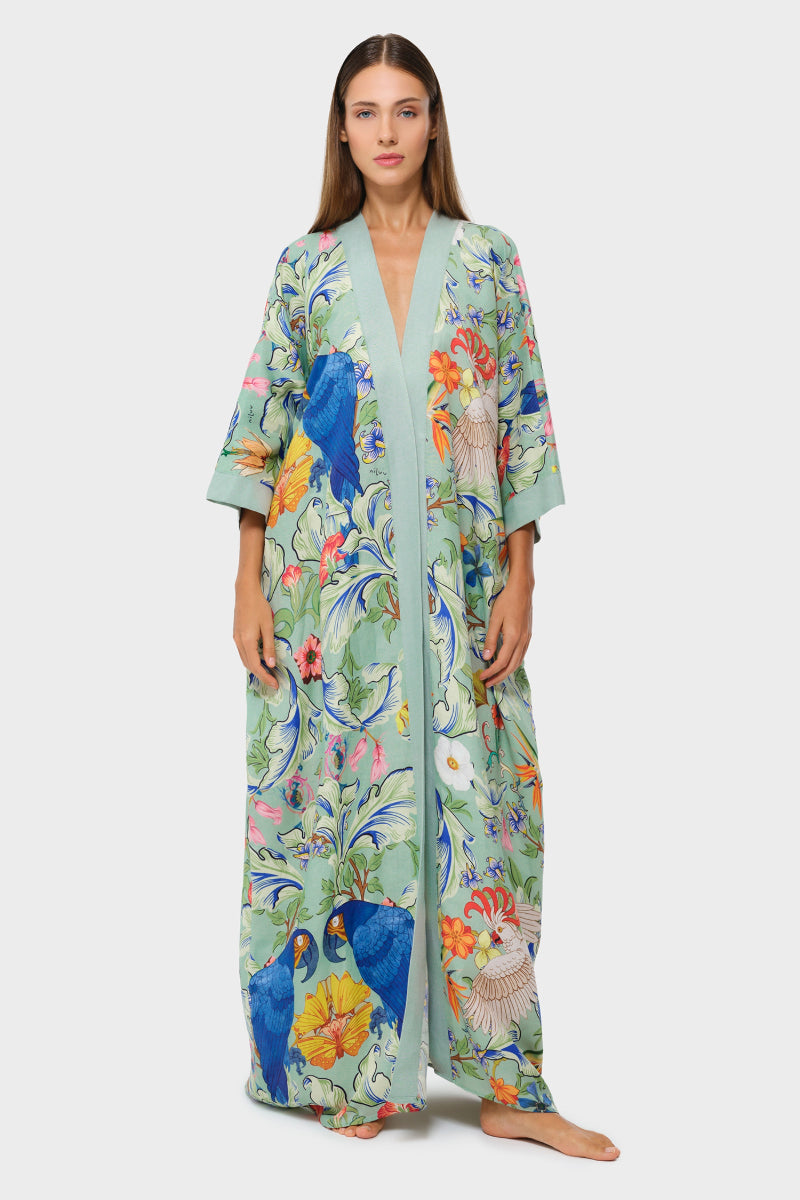 Light blue niLuu Carmen kaftan cover-up with flowing fabric and intricate embroidery, perfect for beach or resort wear.