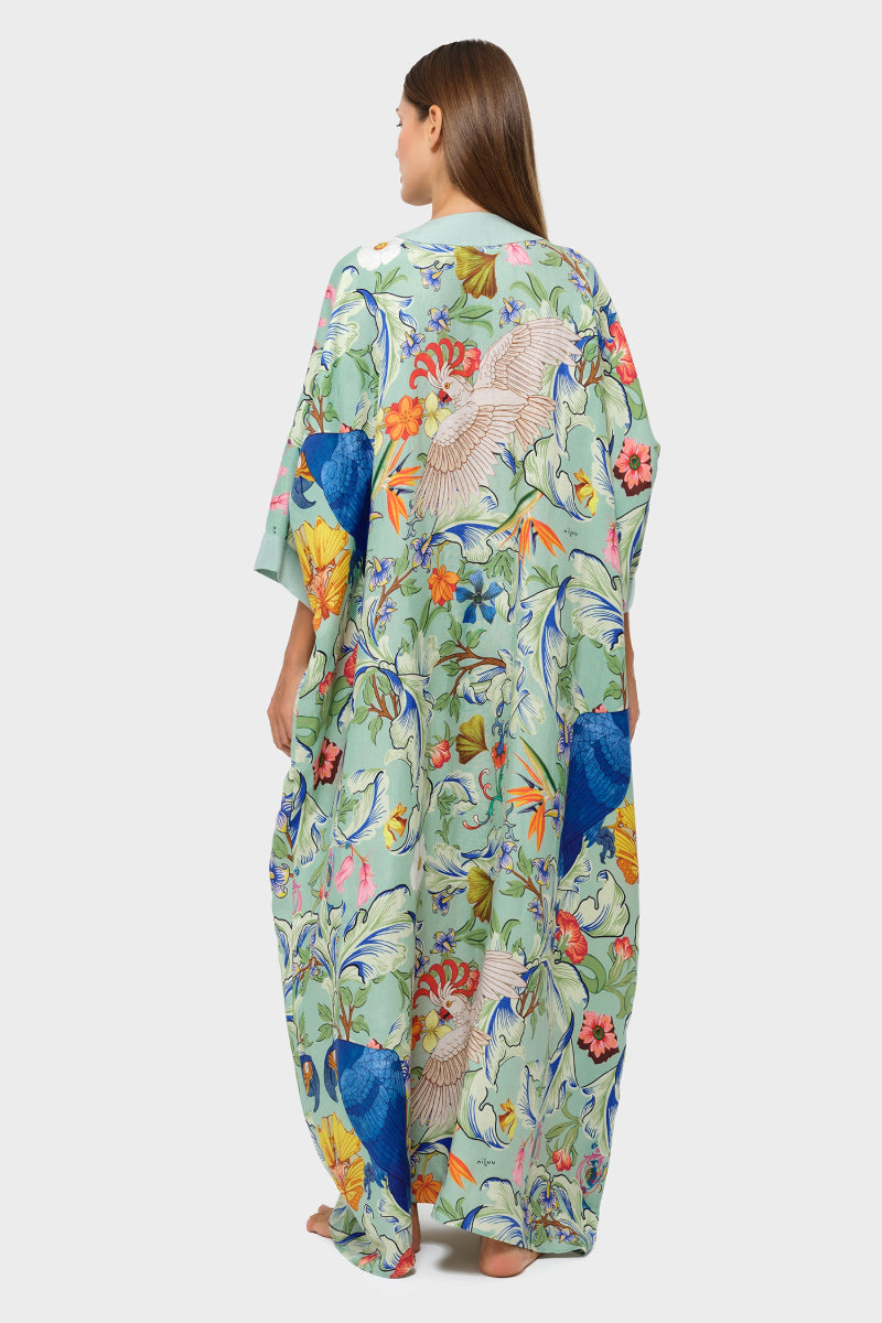 niLuu Carmen Kaftan cover-up featuring vibrant floral patterns and flowing fabric, perfect for beach or poolside wear.