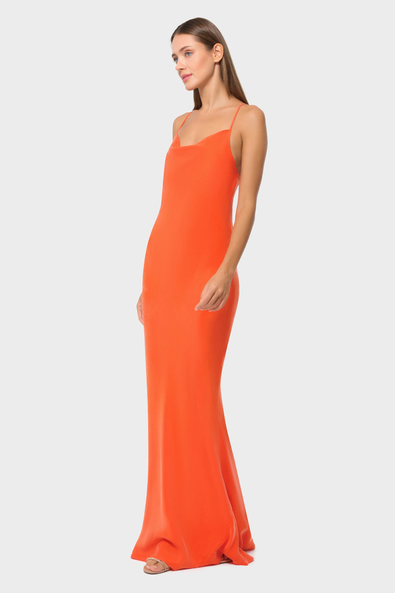 NiLuu Ember Scarlet Slip Dress, a stylish maxi dress with a flowing silhouette and vibrant red color, shown on a model.