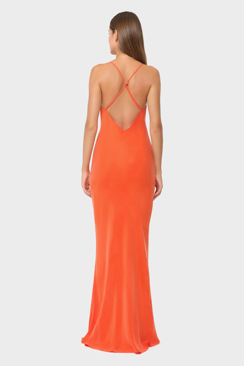NiLuu Ember Scarlet slip dress, a flowing red maxi dress with a sleek silhouette and elegant design, displayed on a hanger.