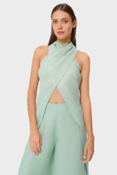 NiLuu Jade Liz cross halter top displayed on a hanger, featuring a stylish cut and vibrant jade color for a trendy look.