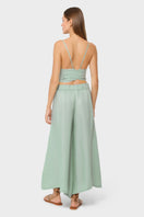 NiLuu jade palazzo pants with wide-leg design and lightweight fabric, shown in a stylish, relaxed fit.