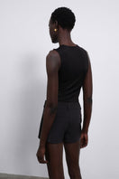 Black Nina fringed knit bodysuit by SÉLONE, featuring fringe detailing and a fitted top design.