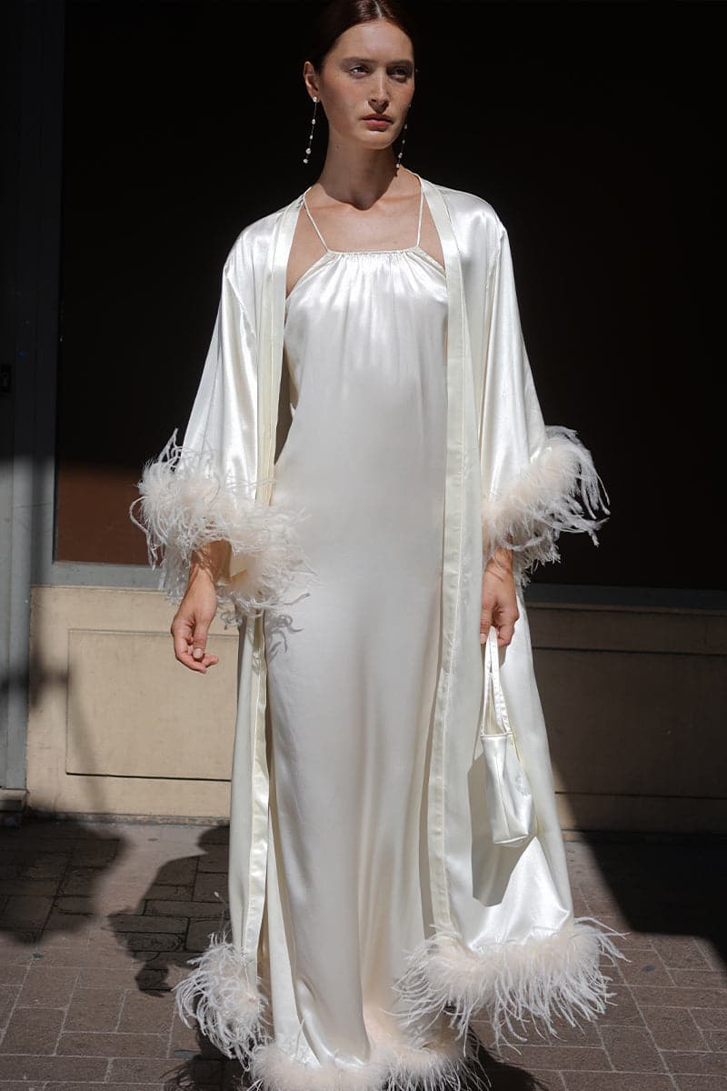IVORY BRIDE-TO-BE HALTER NECK SILK MAXI DRESS WITH REMOVABLE FEATHERS | CULT MIA | Not Just Pajama IVORY BRIDE-TO-BE HALTER NECK SILK MAXI DRESS WITH REMOVABLE FEATHERS | CULT MIA | Not Just Pajama