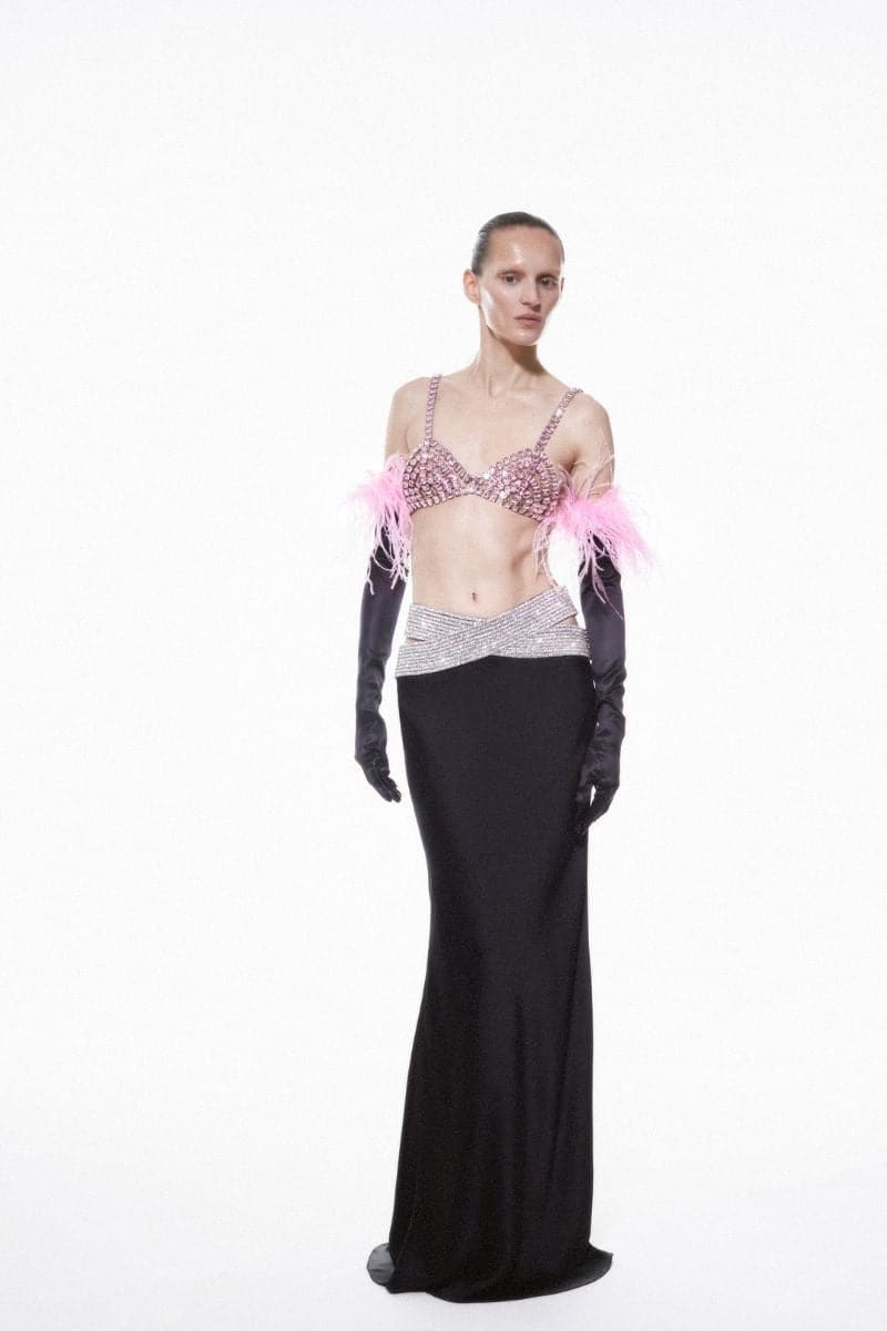 Pink rose quartz embellished Nué bra, featuring intricate beadwork and delicate straps, styled as a fashionable top.