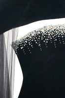Elegant black velvet gown with cape details by Happy Clothing, featuring a flowing silhouette and luxurious fabric.