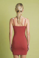 Pink orchid mini dress in dragon fruit print by Laura Escobar, shown from the back with a fitted silhouette and short sleeves.