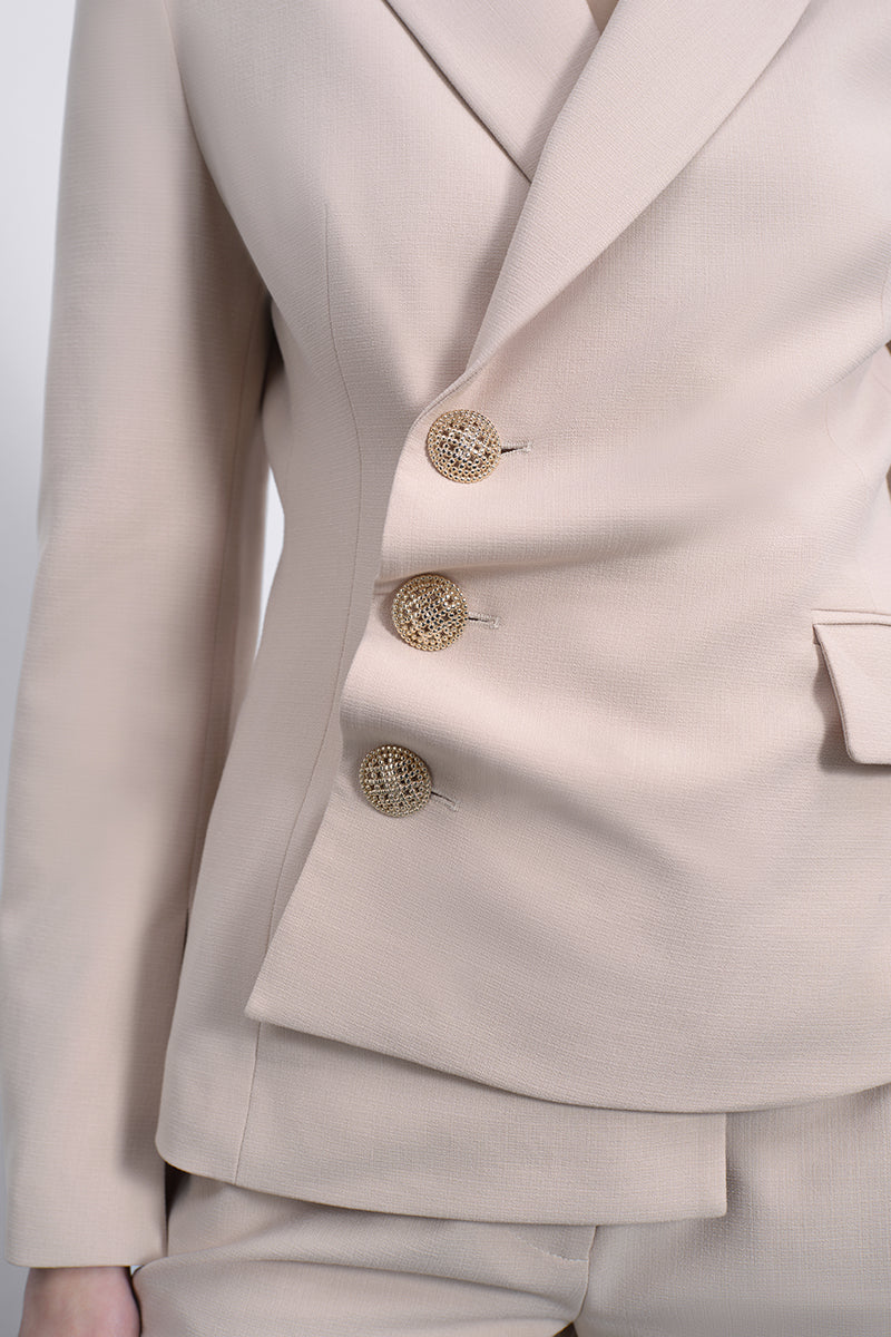 SÉLONE ORIS asymmetrical tailored blazer in warm beige, featuring a modern twist and structured fit.