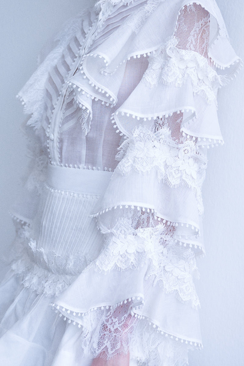 AISA Pearl Shirt featuring a classic design with pearl accents, displayed on a hanger against a neutral background.