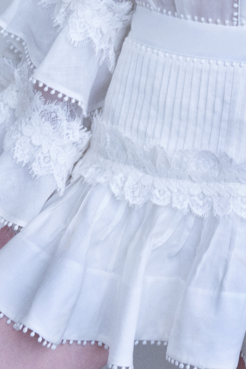 AISA pearl mini skirt with pearl embellishments, stylish and fashionable, shown in a close-up view.