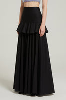 Black Nara Niro peplum maxi skirt with a flowing silhouette and stylish peplum detail.