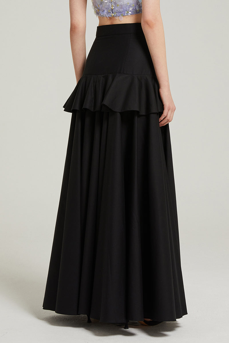 Black peplum maxi skirt by Nara Niro, featuring a flowy silhouette and stylish peplum detail for elegant, everyday wear.