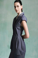Lecia peplum top in black with fitted waist and flared hem, shown on a model against a neutral background.