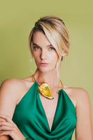 Emerald green Lily mini dress by Laura Escobar, close-up of fitted bodice and short sleeve design on model.