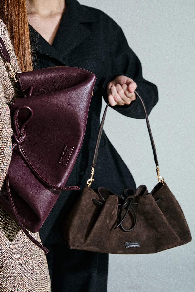 Chocolate brown Arabesque bucket shoulder bag by Rose de Mai with intricate design and spacious interior.