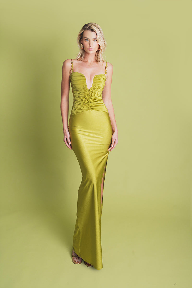 Light green pistachio maxi dress by Laura Escobar, flowing fabric, sleeveless design, perfect for warm weather occasions.