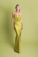 Pistachio-colored maxi dress by Laura Escobar featuring a flowing fabric and elegant design, suitable for summer or special occasions.