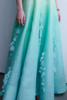 AISA PIA gown featuring elegant fabric and intricate design, showcased on a hanger with detailed embroidery visible.