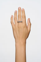 Elegant crystal flow ring by Poché featuring a sparkling design, showcased on a hand with a focus on the intricate band.