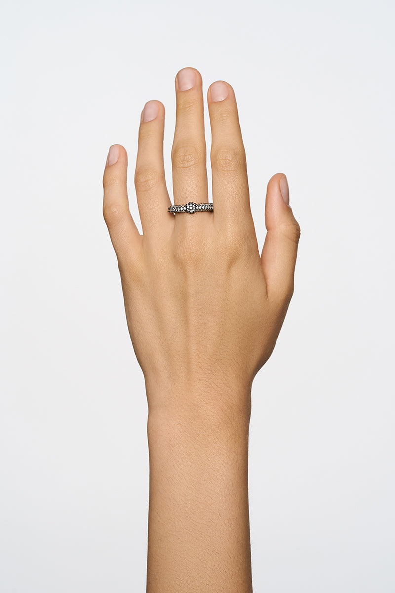 Elegant crystal flow ring by Poché featuring a sparkling design, showcased on a hand with a focus on the intricate band.