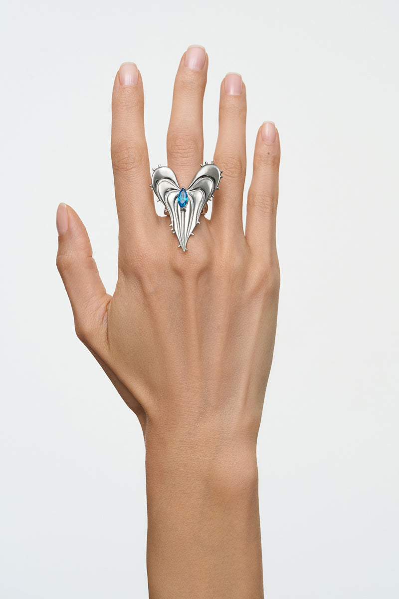 Silver leaf ring by Poché featuring a delicate, nature-inspired design with detailed leaf motifs on a sleek band.
