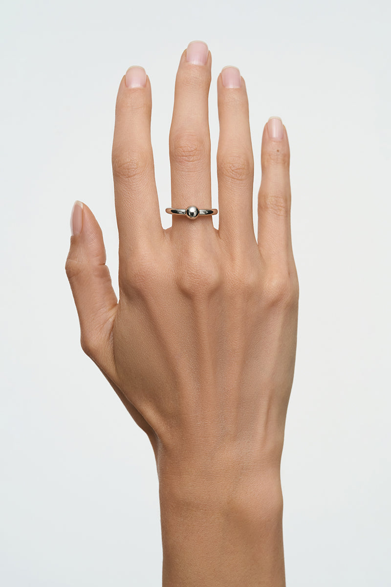 Silver Flow Ring by Poché, minimalist unisex jewelry ring with smooth, flowing design on a plain background.