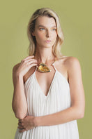 Close-up of the ivory Portobello maxi dress by Laura Escobar, showing the fabric texture and elegant design details.