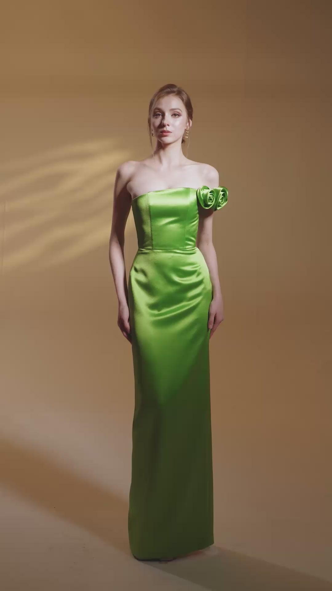 GREEN BUSTIER GOWN ADORNED WITH SATIN FLORAL APPLIQUÉ
