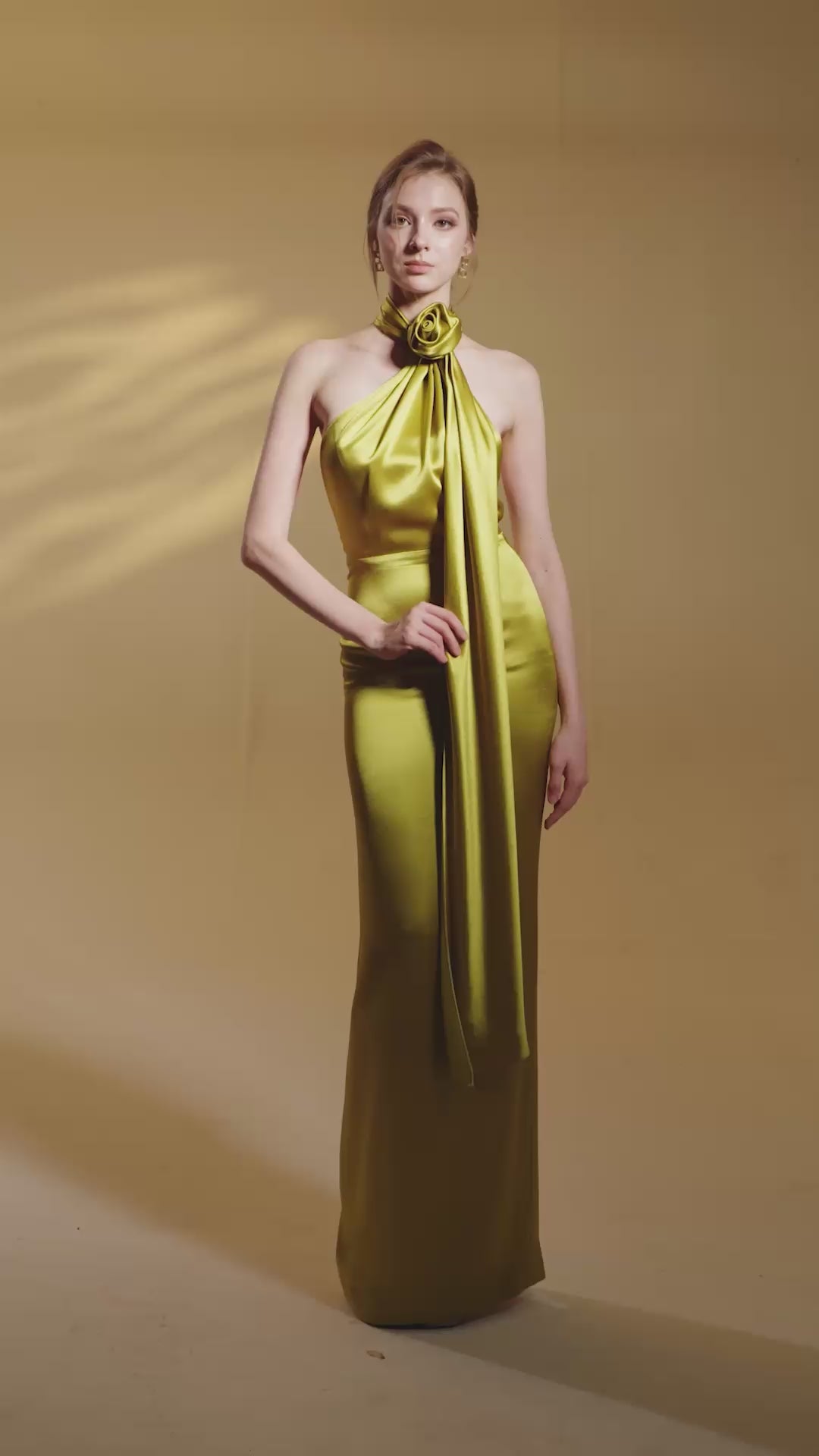 GOLD HALTER DRESS WITH CROSS DETAIL AND PLEATED DRAPE