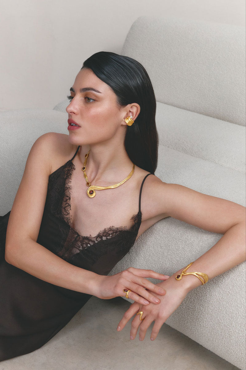 Gold and blue drape bracelet by Jude Benhalim featuring elegant, flowing design with intricate details.