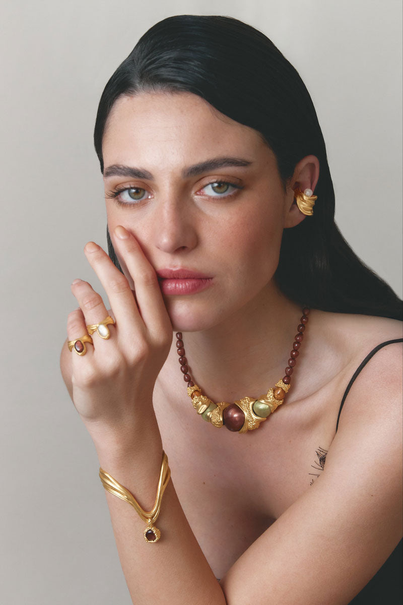 Gold and white drape bracelet by Jude Benhalim featuring elegant, flowing design and intricate details.
